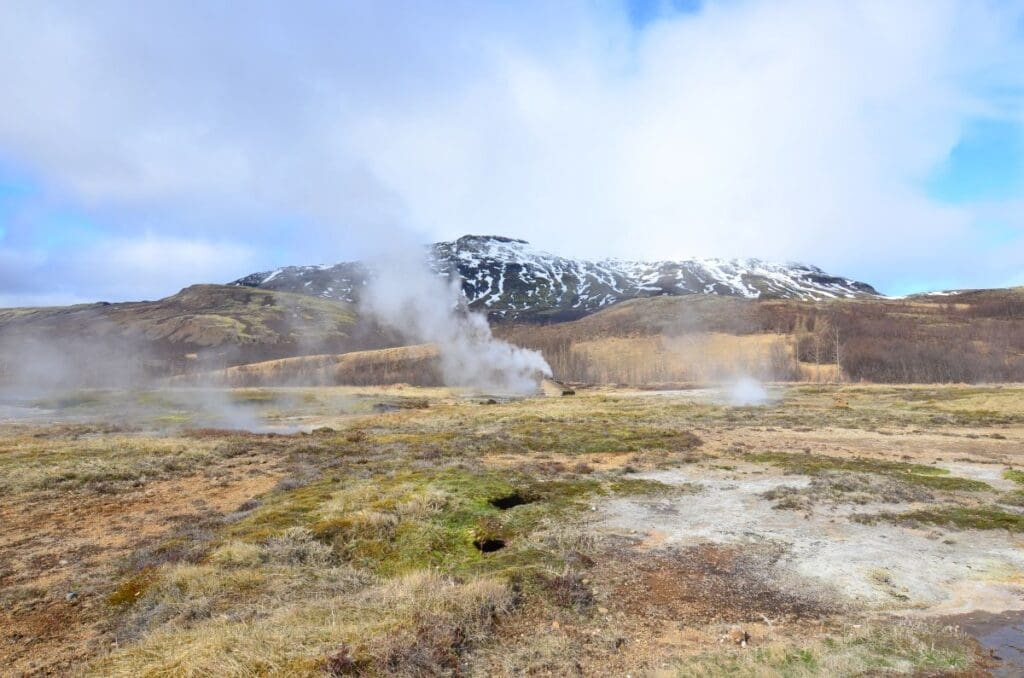 Global warming unveils hidden diversity in soil bacteria, study finds Image: A field in Iceland with a scenic view of the geysirs