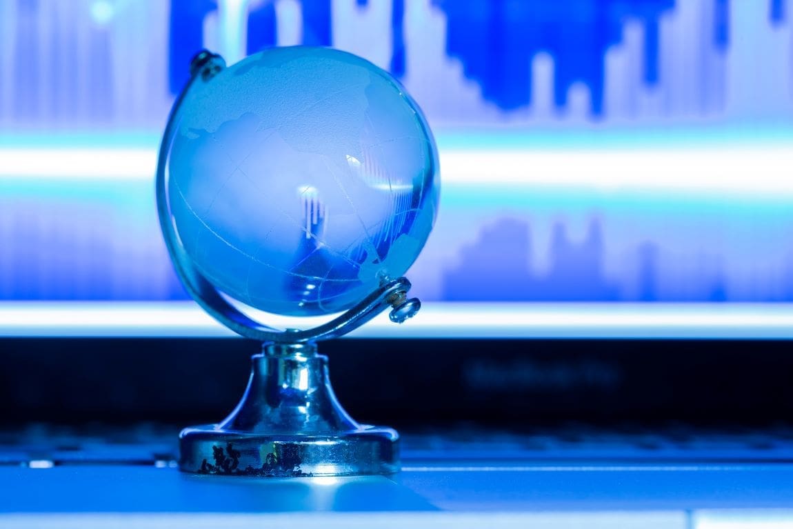 The business concept of the glass world on a laptop (s. climate, aid, science, news,globe,US energy)