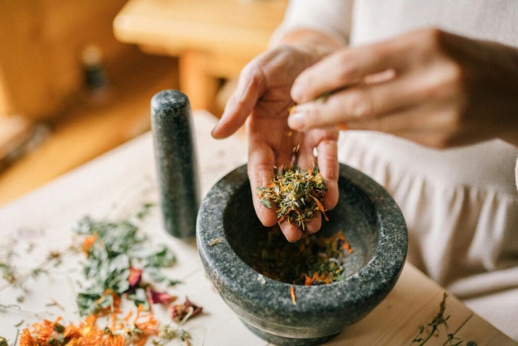 Image: Close-up of Woman Preparing Herbs in Pounder