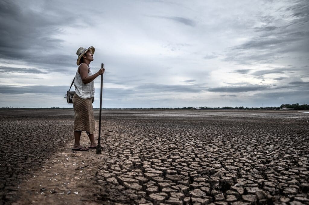 Climate change is a human rights issue women standing dry soil fishing gear global warming water crisis res