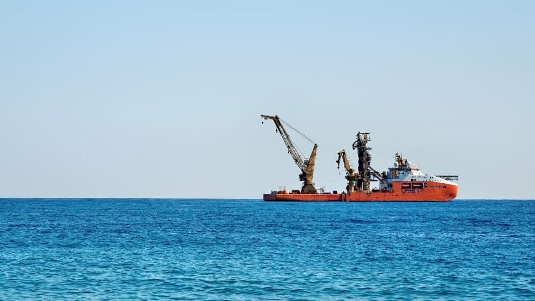 Image: Working industrial cargo ship in the sea (mining)