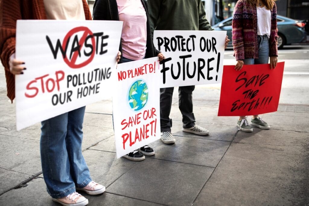 Climate lawsuits against companies on the rise: report people world environment day protest with placards outdoors res