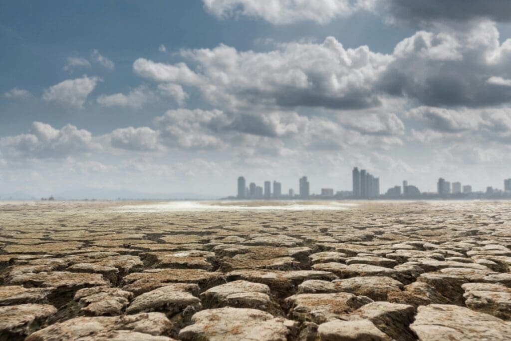 Severe warming could slash global GDP by 40%, new study finds Image: Dry ground with megalopolis on background