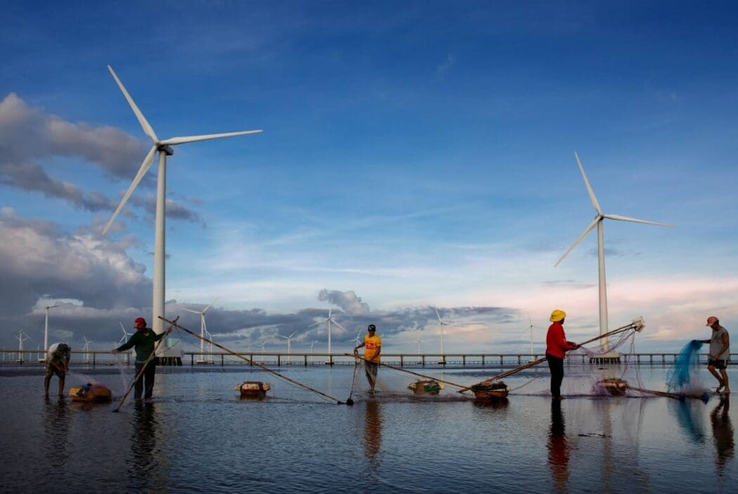 Image: Fisherman working near wind turbines
