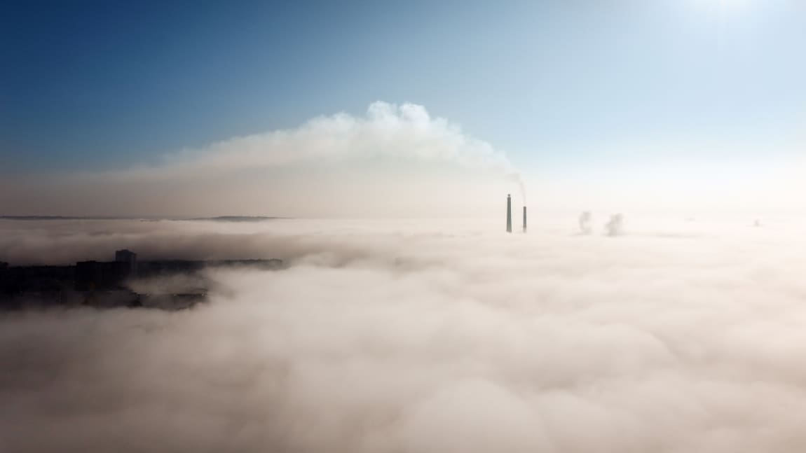 Aerial view of a foggy city (pollution / carbon dioxide - high concentration)