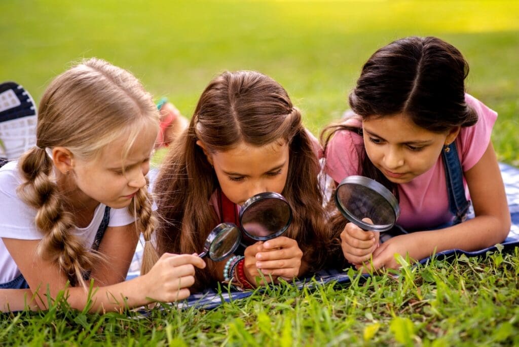 Learning beyond the classroom – bringing science teaching into the real world girls looking grass through magnifying glass res