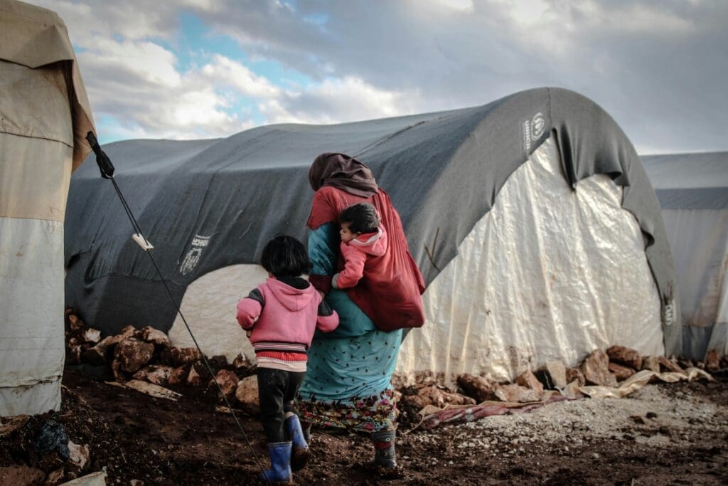 Image: Woman with Kids Walking on Mud
