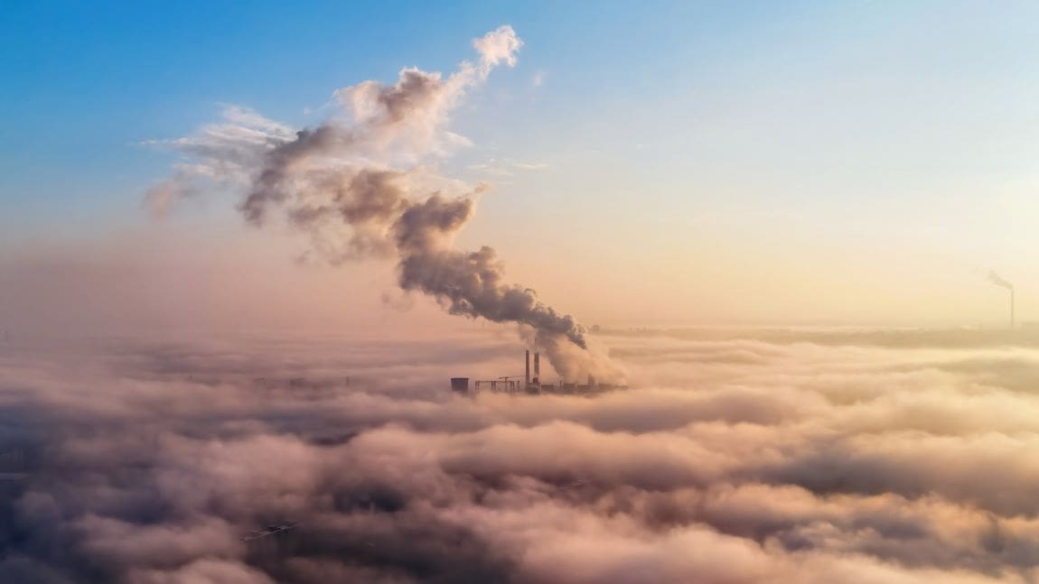 Image: View of a thermal station in the distance above the clouds, columns of smoke (s. fossil fuel emissions, climate)