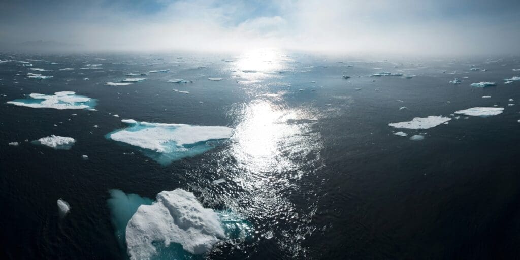 Image: Greenland ocean sunset | landscape and aerial photography of icebergs on body of water during daytime