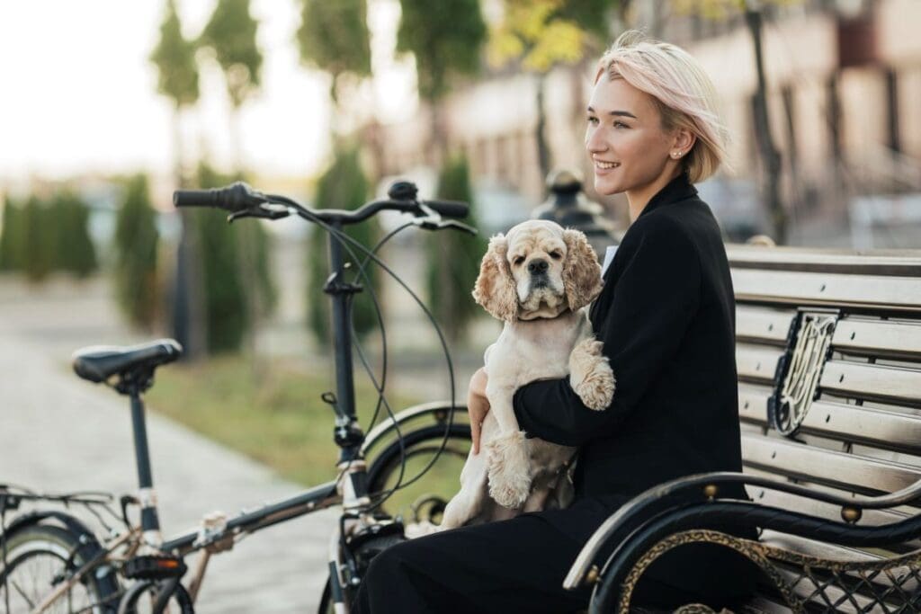 Shift focus to well-being, not growth: a new approach for climate-smart living pretty woman petting her cute dog res