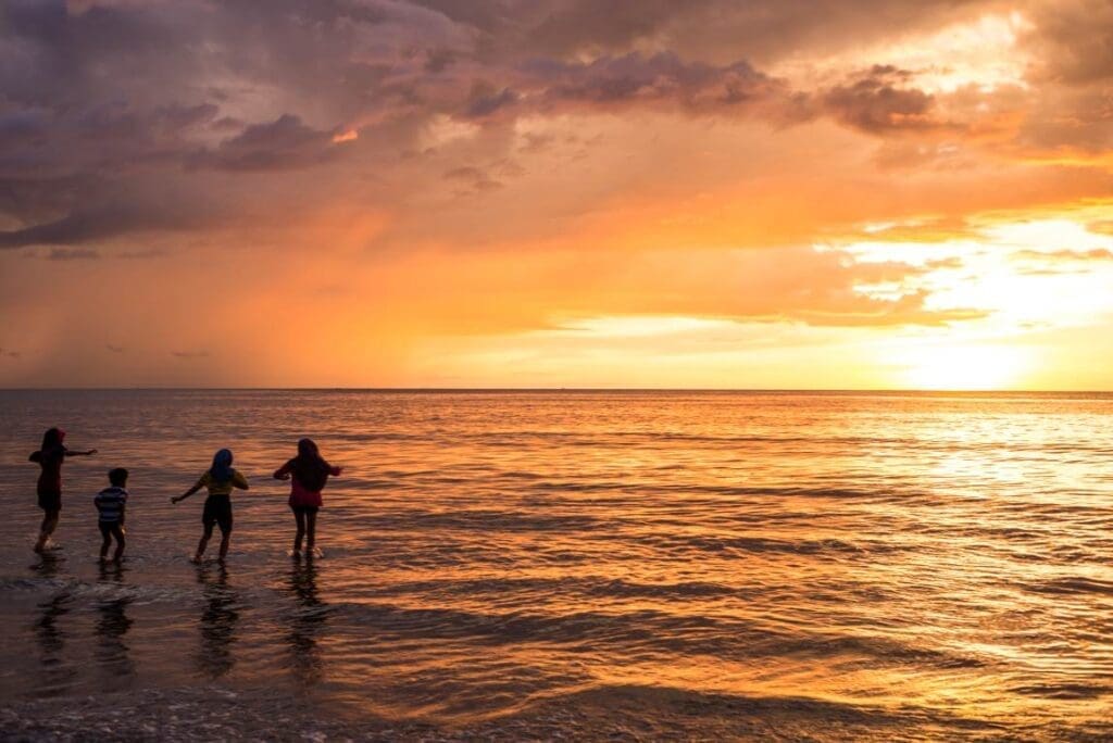 Image: Kids silhouettes, Sunset, Ocean (s. Economy, Climate Change)
