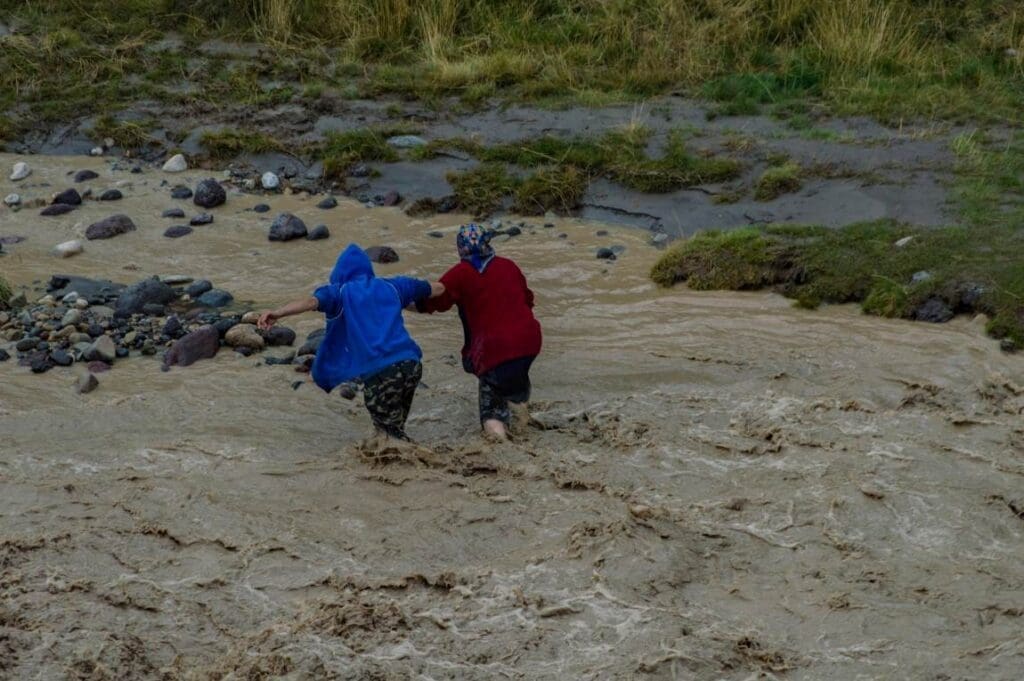 Image: People Crossing River in Flood