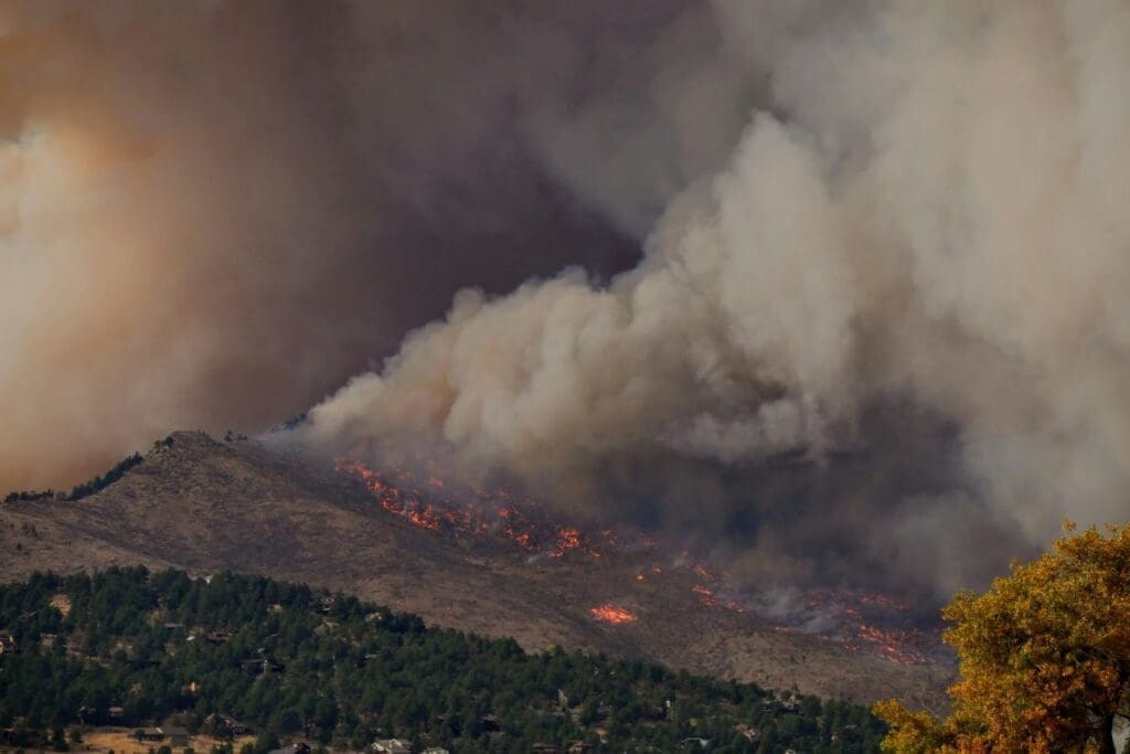 Image: white smoke coming from a gray clouds (wildfire)