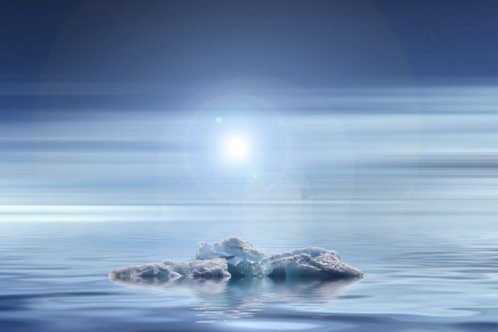 Small iceberg floating in ocean water under a bright sky with the Sun visible above - climate change effects (s. science, Muser)