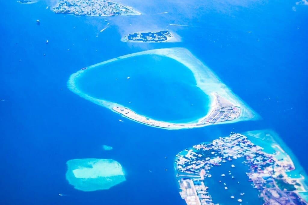 Small island nations face growing flood risk despite minimal climate impact Image: Island plane summer travel water
