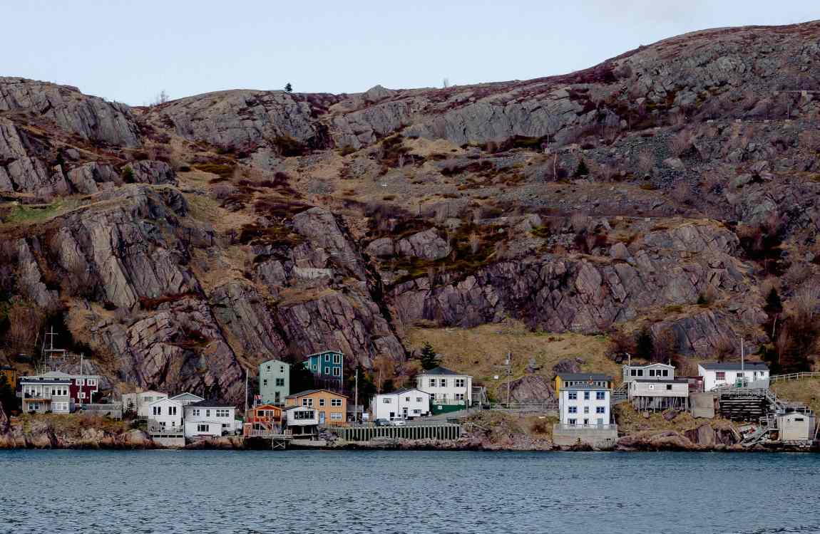 Image: White and Gray Buildings Beside Water and Hill