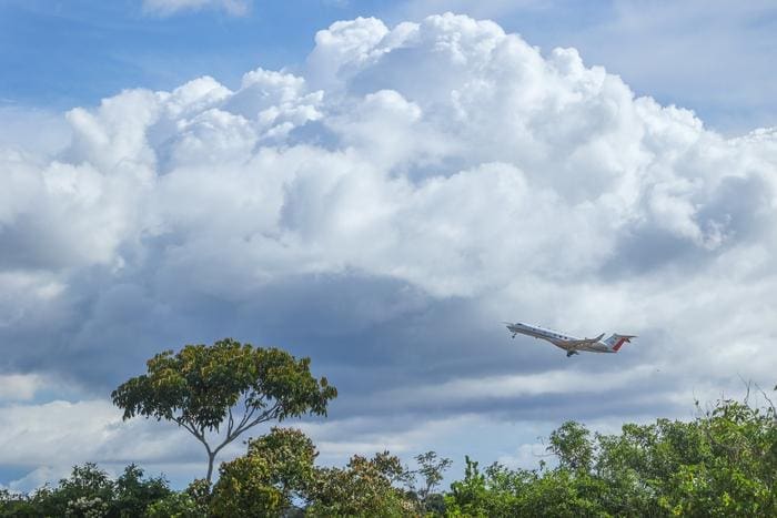Image: Aircraft shortly after take-off with clouds in background - Amazon Rainforest