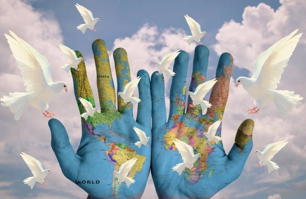 Draw of World map on two hands and doves flying