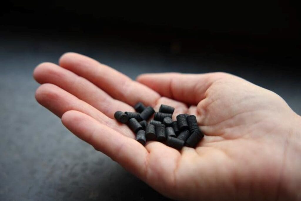 A small handful of biochar in pellet form