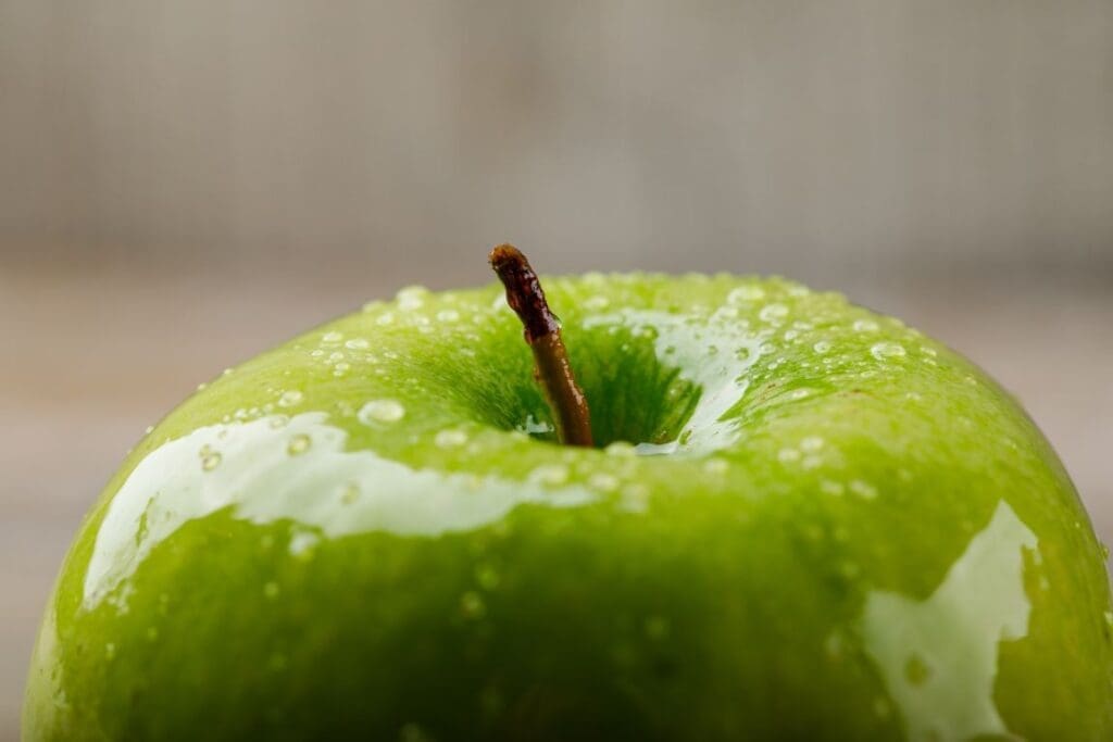 Sour green apple on a grungy background