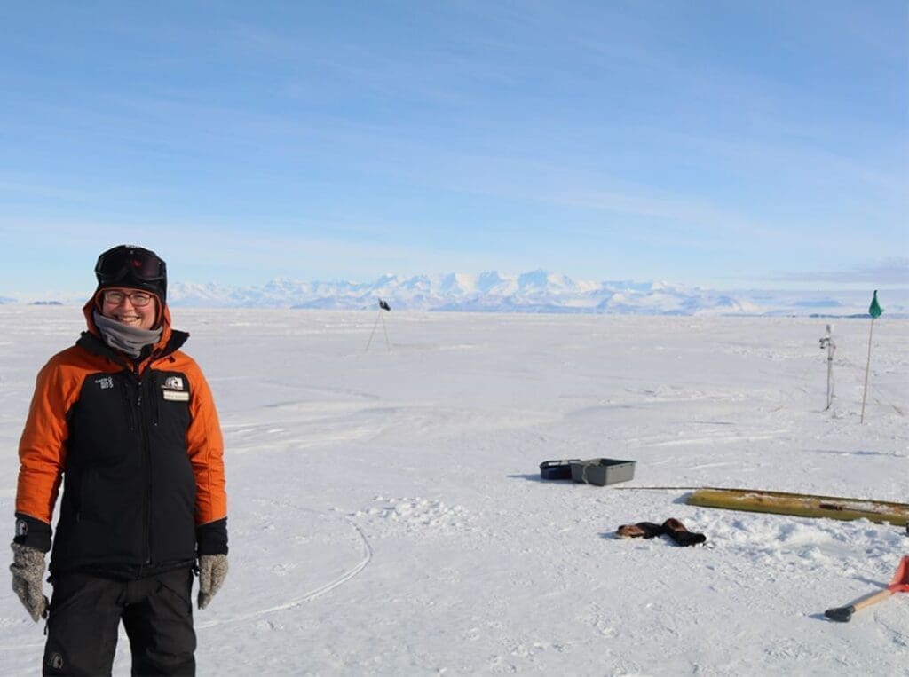 Maren Richter on the fast ice next to a measurement site from which a sea ice core was taken