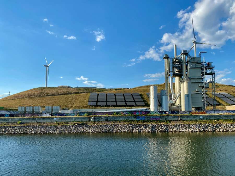 Solar Light Panels on Grass Near Windmills