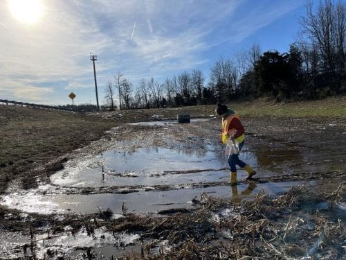 Megan Rippy collects soil samples at a stormwater detention basin along Interstate 95 in Northern Virginia