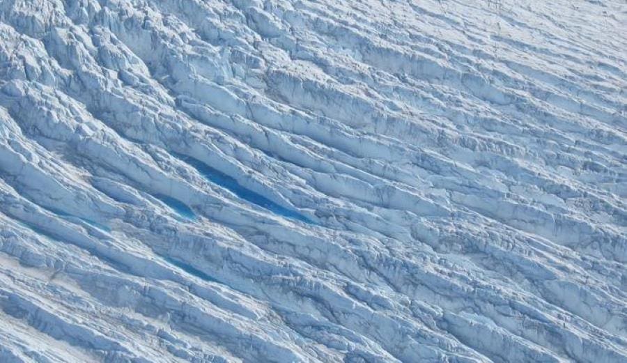 Greenland's ice is cracking faster as climate change accelerates glacier flow Aerial image: Photograph taken from a helicopter in 2006 of crevasse fields on Sermeq Kujalleq, Greenland