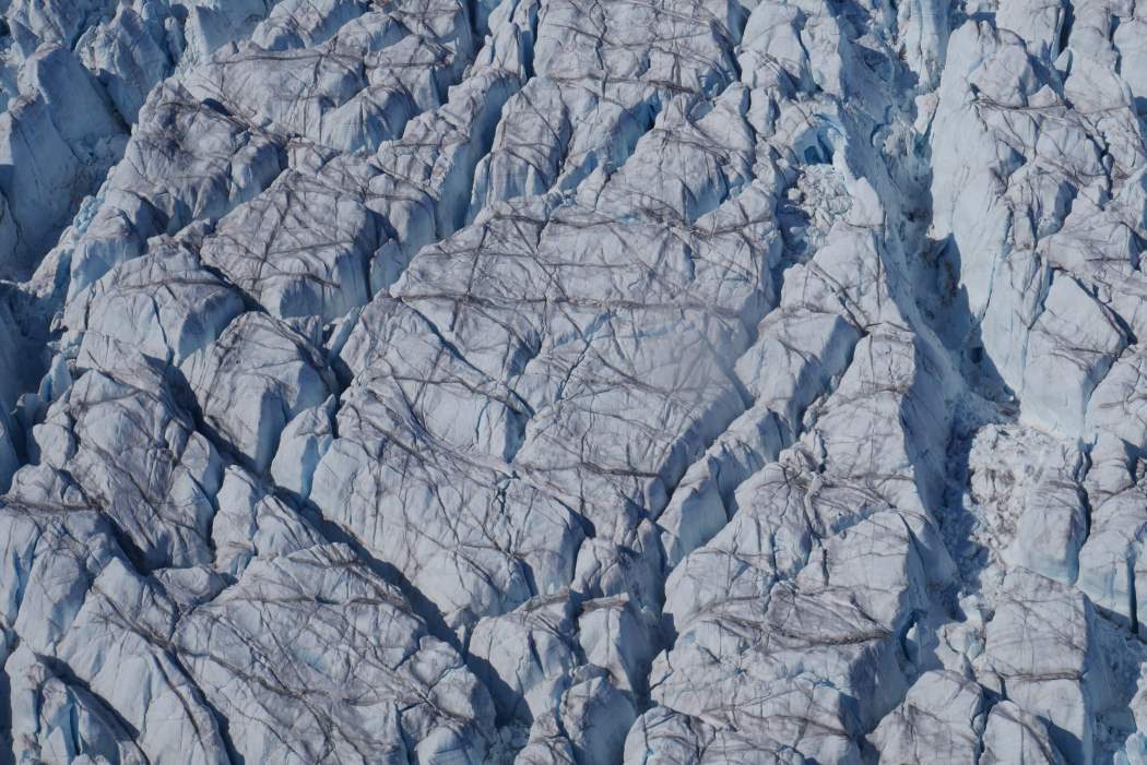 Greenland’s ice is cracking faster as climate change accelerates glacier flow