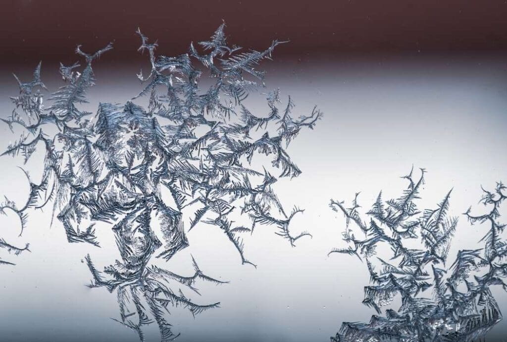 Closeup shot of a snowflake on a glass from frost (s. freeze, climate, global warming)