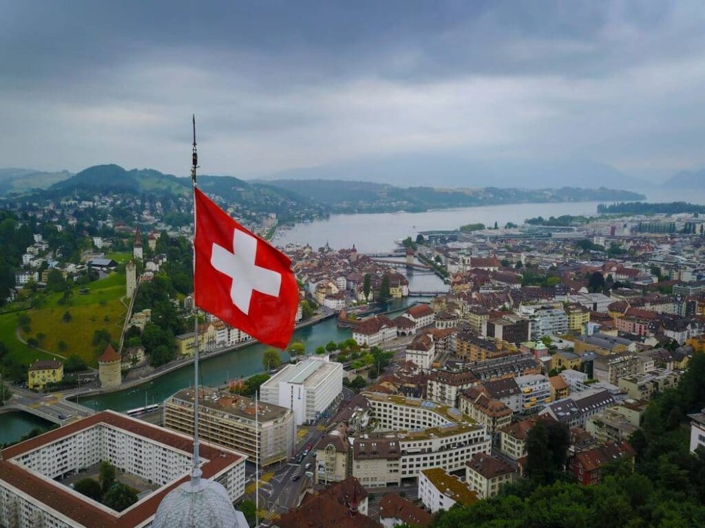 Swiss vote rejects placing ecology at heart of constitution Aerial Shot of Switzerland Flag Waving over Lucerne (s. Swiss, environment)