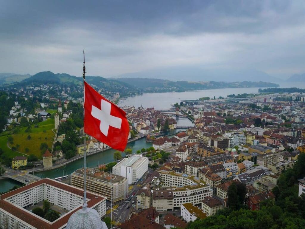 Aerial Shot of Switzerland Flag Waving over Lucerne (s. Swiss, environment)