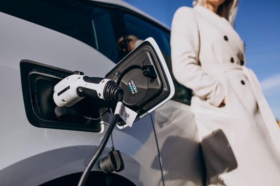 Woman charging electric car