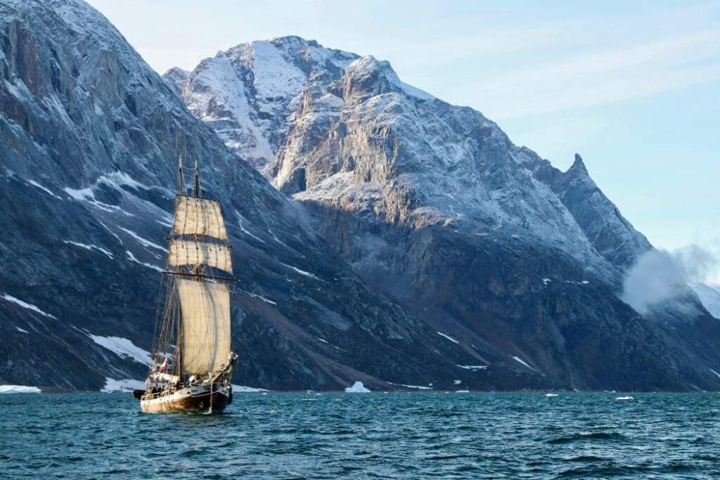 Image: Boat on sea near mountain (s. Scoresbysund, Greenland)
