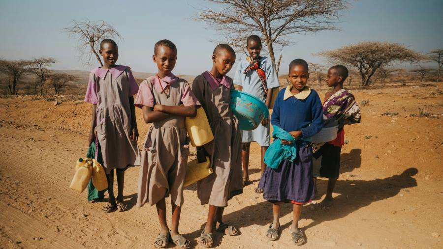 Climate change deepens health risks for young adolescents in Kenya Image: six children standing on desert, Kenya (s. health. climate change)