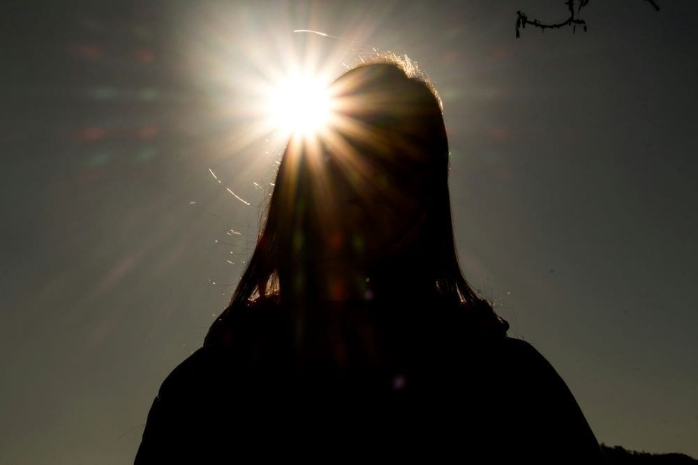 Image: silhouette of person with Sun in background (s. heat, health, mental health, climate change)