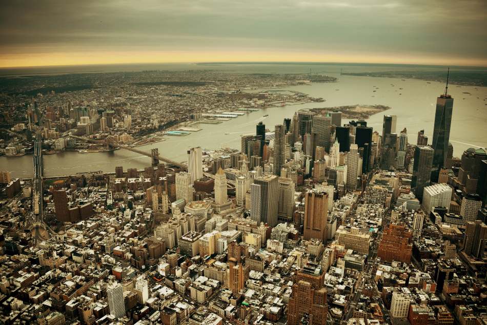 Major US cities are sinking as land subsidence threatens infrastructure Image: New York City Manhattan downtown aerial view with bridges