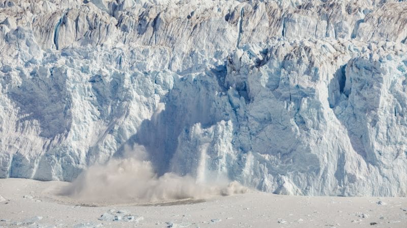 Image: An ice tower breaks off from the 80-meter-high ice front of the calving Eqalorutsit Kangilliit Sermiat glacier in southern Greenland 