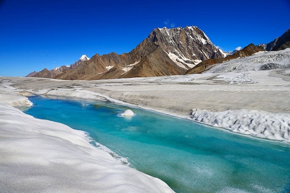 Melting glaciers boost Himalayan river flow but threaten long-term water security Image: Glacial stream on Hispar glacier