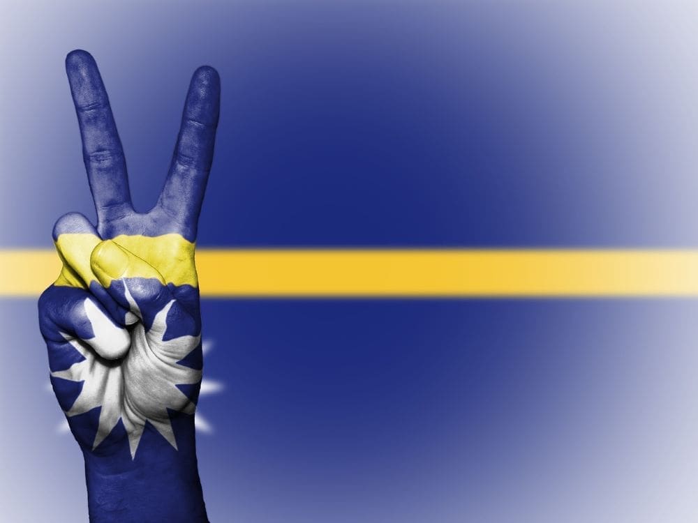 Pacific microstate sells first passports to fund climate action Image: Nauru flag, peace sign