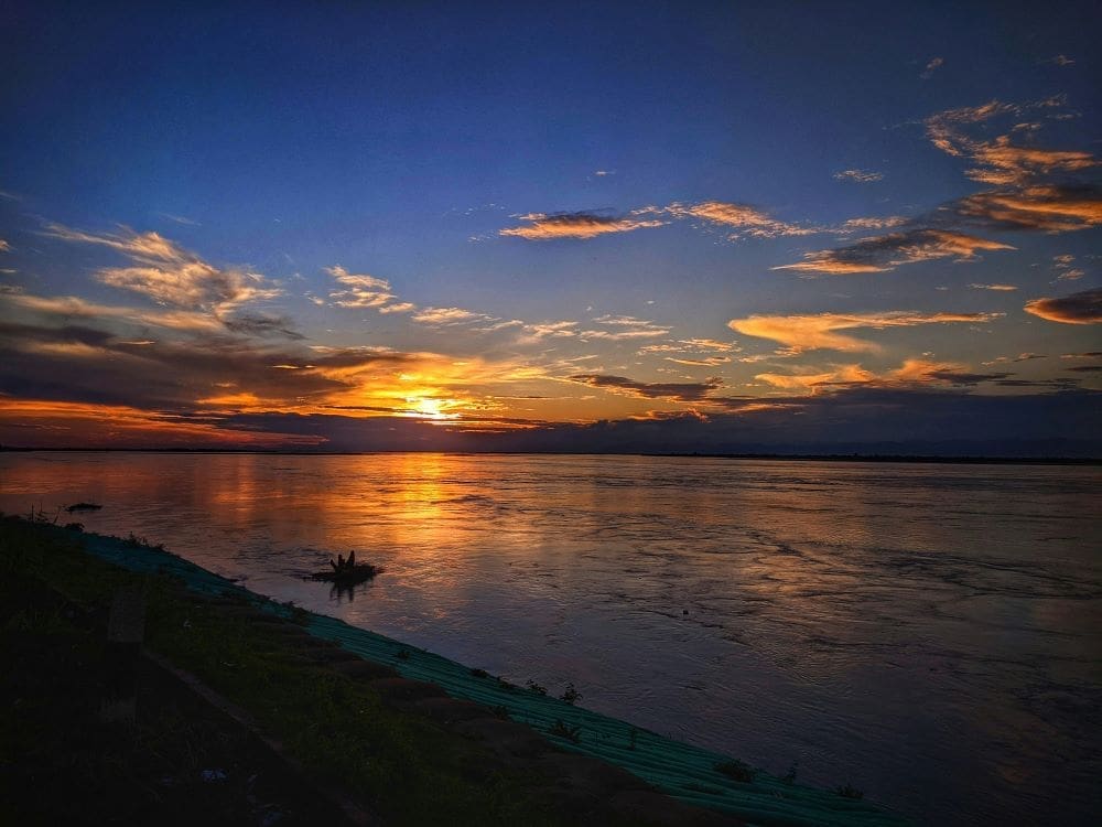 India plans mega-dam to counter China water fears Image: Sunset, Brahmaputra River, in Assam