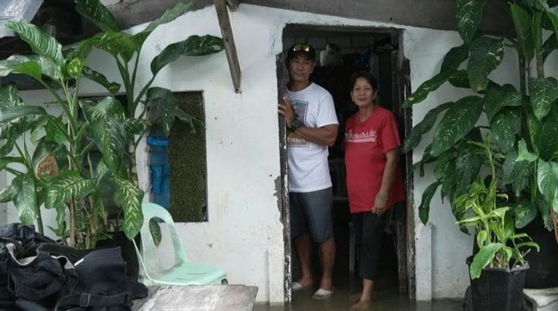 Image: Rodolfo Tamayo and his wife Maria Tamayo inside their flooded house on Pugad Island