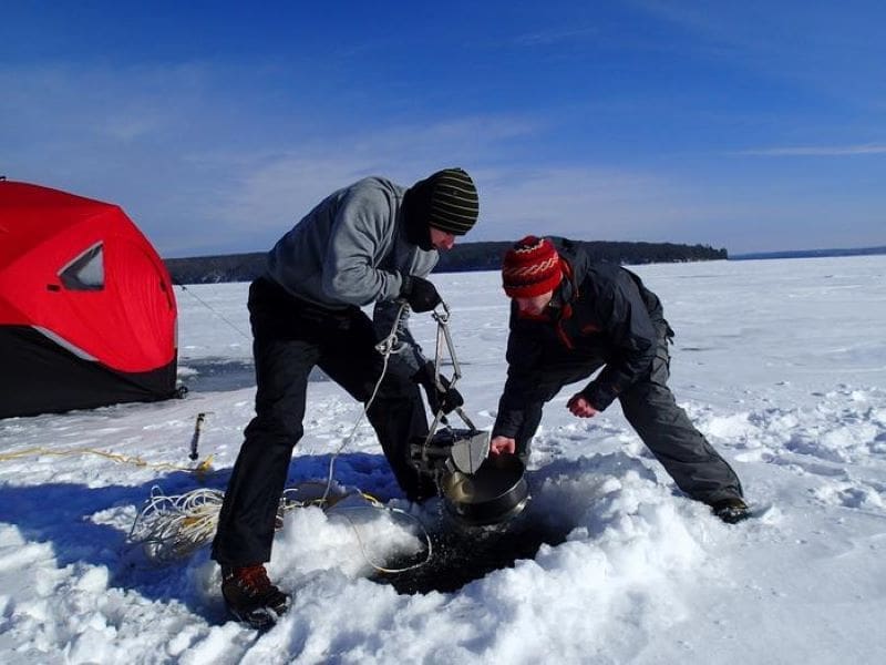 Image: researchers collecting samples from frozen Lake Superior