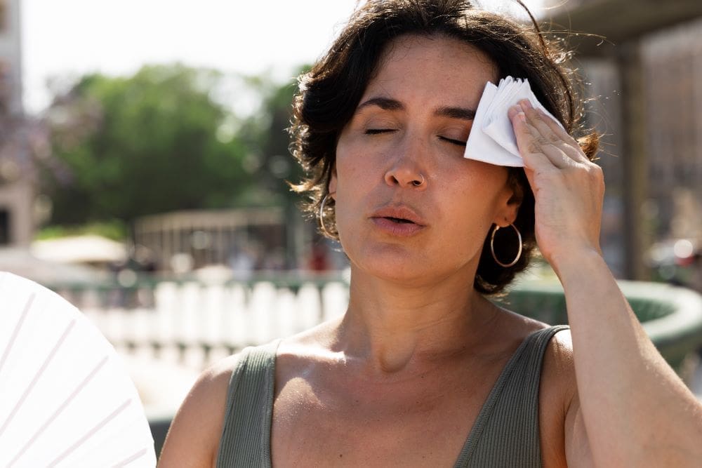 Climate Science Digest: January 6, 2026 Image: woman struggling with high temperature (s. heatwave, climate change)