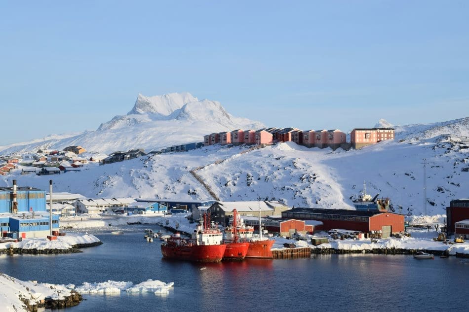 Greenland's west coast posts warmest January on record Image: red and white ship on sea near mountain (s. Nuuk, Greenland)