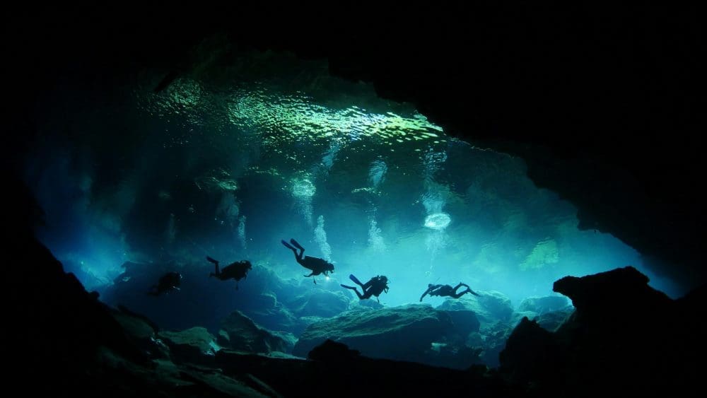 In Finland, divers learn to explore icy polar waters Image: Divers in Underwater Cave