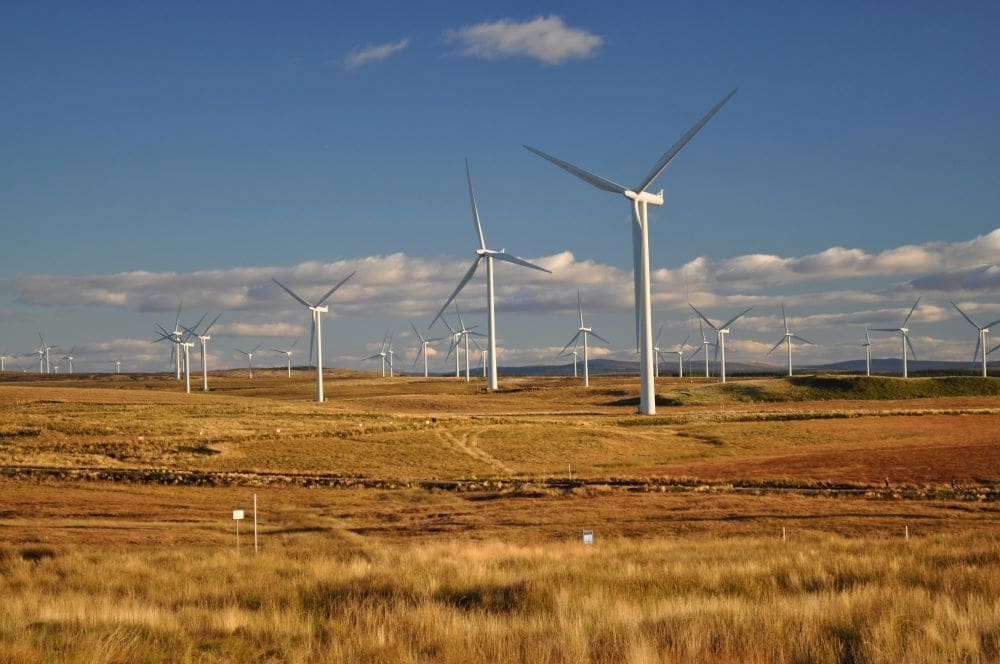 Image: White Windmills Under a Blue Sky - Eaglesham, Scotland, United Kingdom (s. clean energy)
