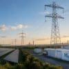 Global fossil fuel phase-out could require up to 80% more electricity Image: Solar panels, wind turbines, electricity transmission towers, and hydrogen infrastructure in a large renewable energy landscape at sunset