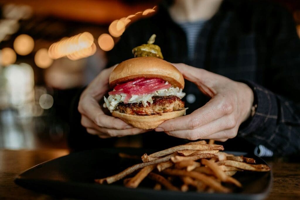 Young people lead dietary emissions as seniors drive the rise Image: a person holding a burger