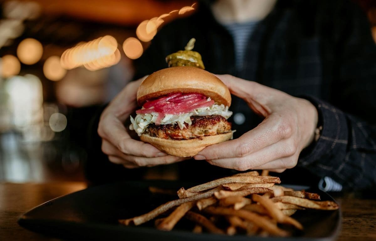 Young people lead dietary emissions as seniors drive the rise Image: a person holding a burger